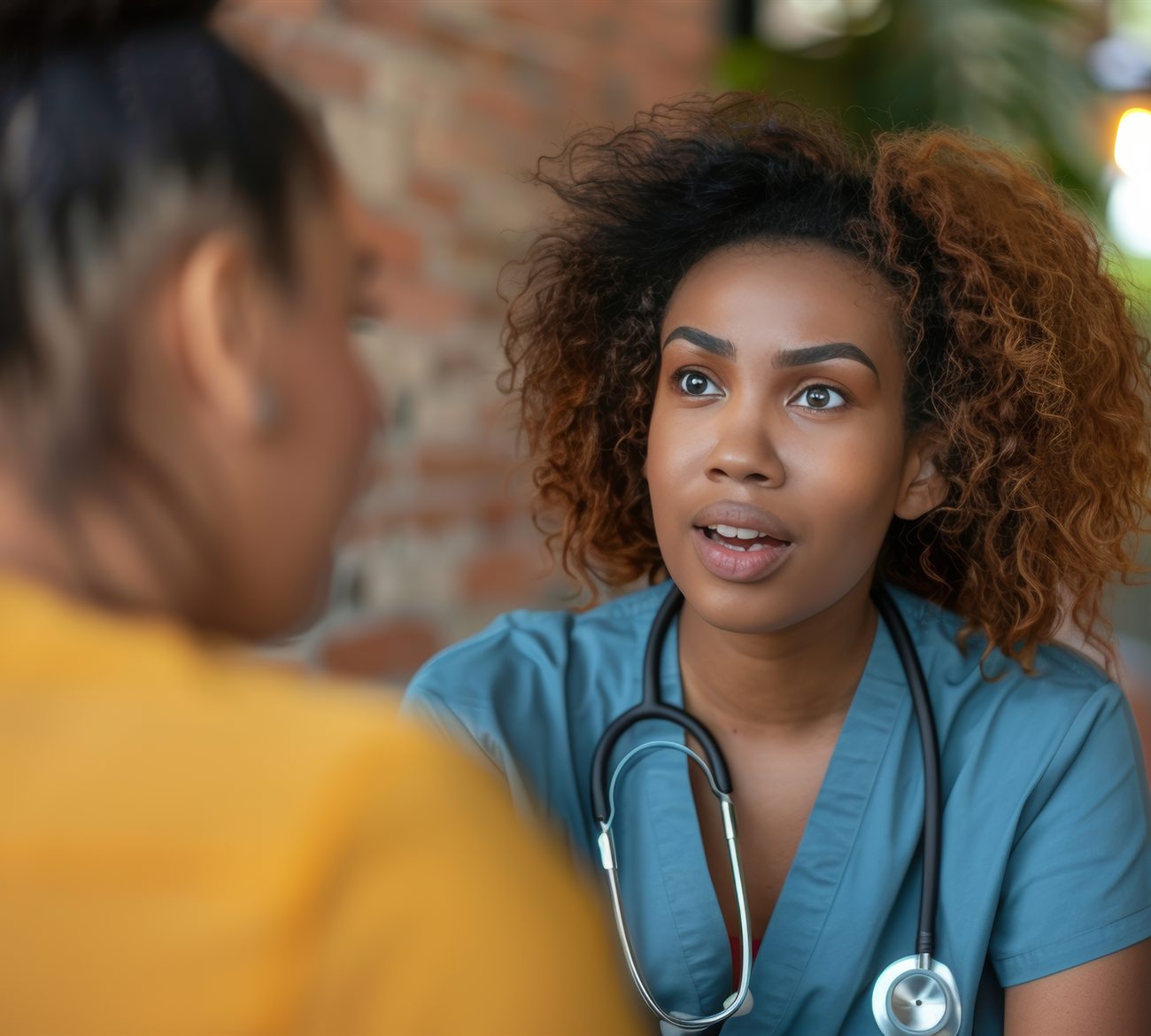 A nurse in conversation with a patient