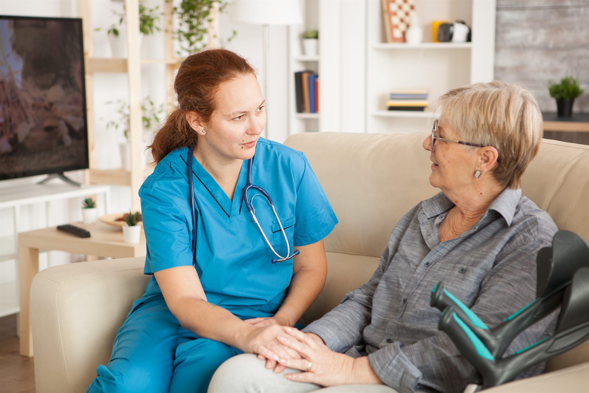 A nurse in warm conversation with an older woman
