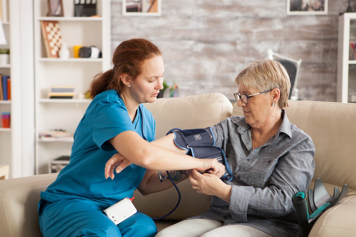 A nurse checking a patient's blood pressure